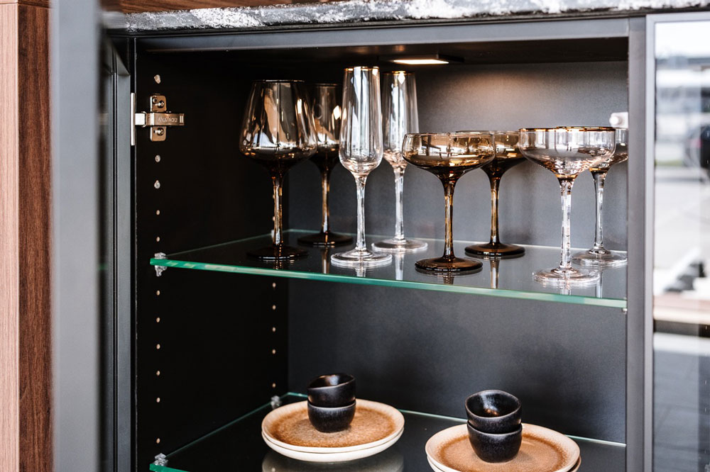 Geöffnetes Küchenkastl mit verschieden Gläsern